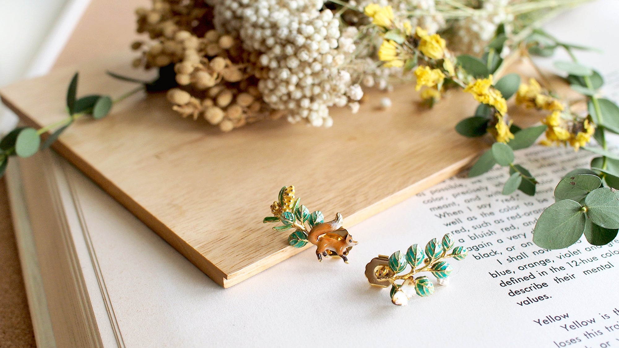 Nature-inspired earrings with a fox butterfly and foliage motif