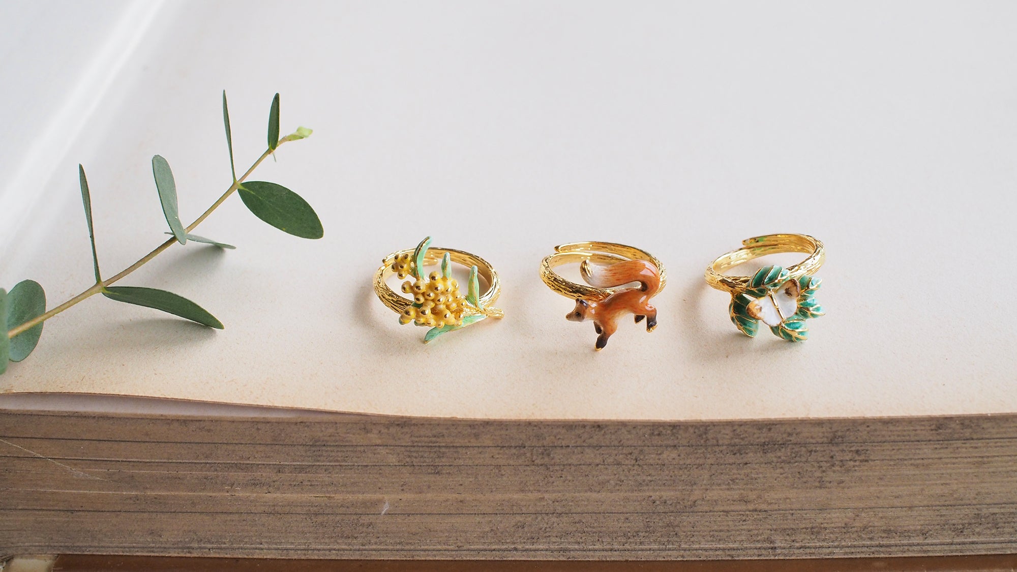 Nature-inspired stacking ring set featuring a fox, butterfly, and flower.