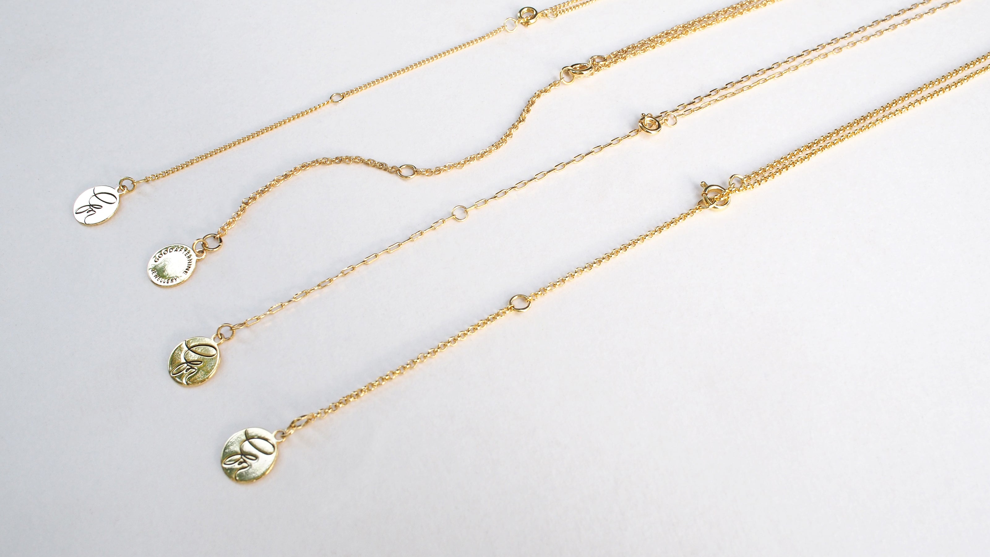 Gold color initial necklaces showcasing different chain styles.