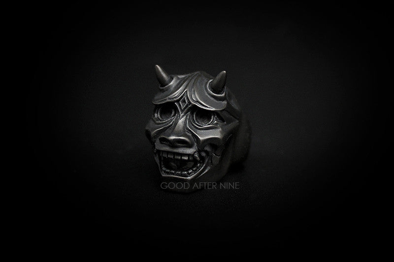 Artisan ring showcasing a dark mask with horns