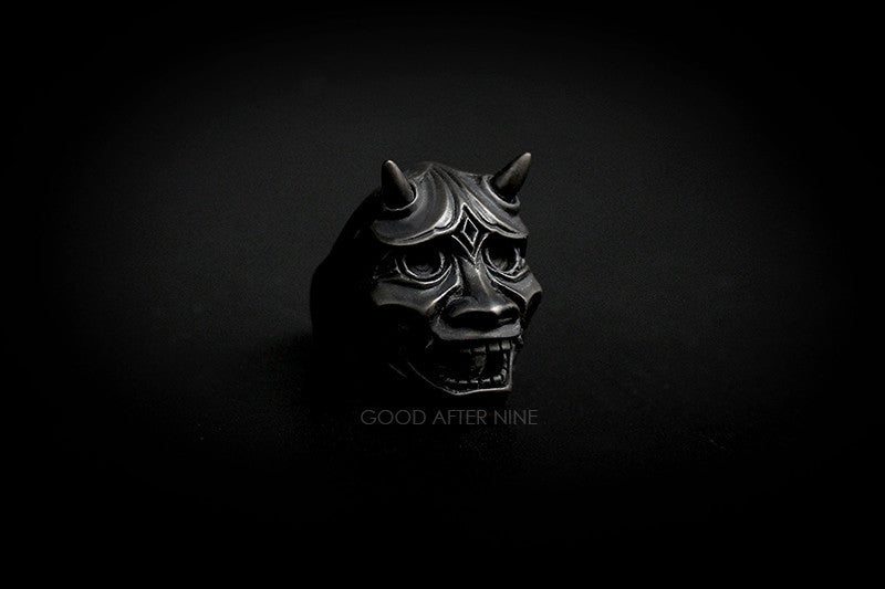 Artisan ring showcasing a dark mask with horns