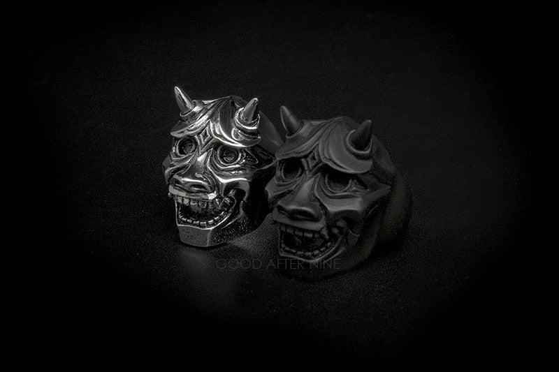 Two intricate devil with horns rings showcasing craftsmanship