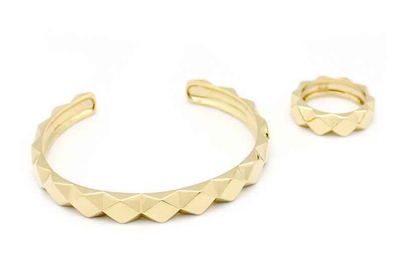 A stylish gold bracelet and ring set, featuring a unique pyramid design.