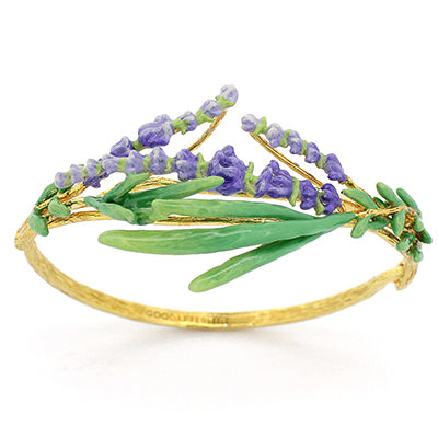 A gold bracelet adorned with green leaves and delicate purple flowers, perfect for flower lovers.