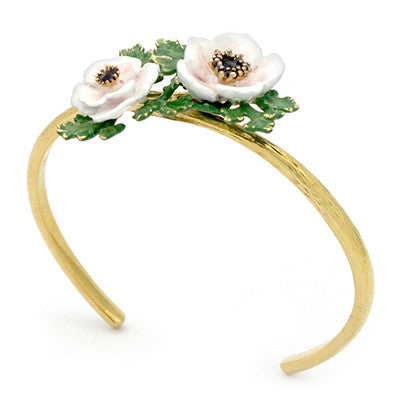 Golden bangle featuring charming light pink flowers and green leaves.