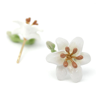 Handmade flower earrings with white petals and brown stamens, accompanied by green leaves and a budding flower.