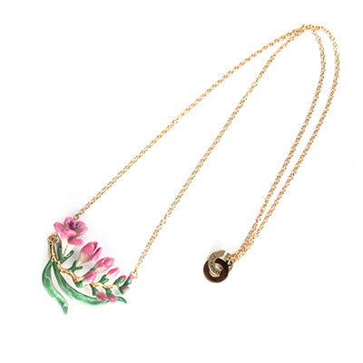 Nature-inspired necklace adorned with delicate pink flowers and leaves.