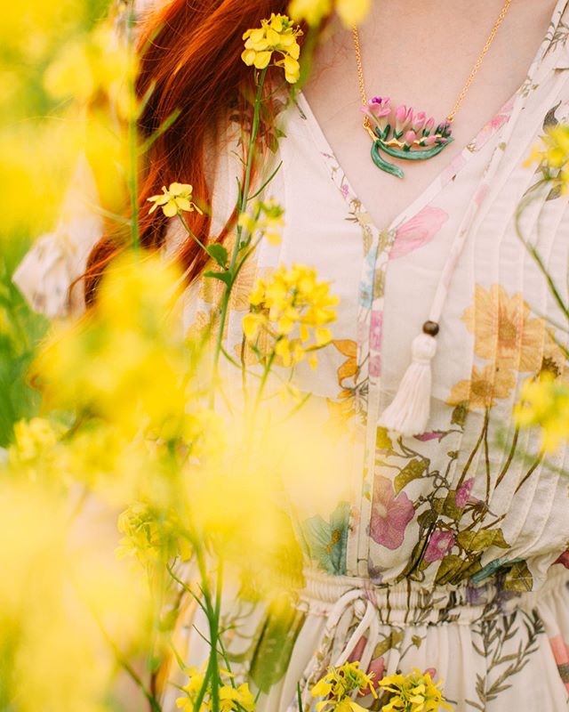 Beautiful flower necklace inspired by nature worn by a woman in a flower field