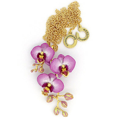 A gold necklace with three purple flowers and golden accents pendant, perfect for summer fashion.