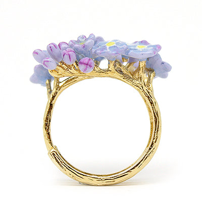 A beautiful floral gold ring adorned with purple flowers.