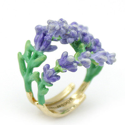 A whimsical gold ring featuring delicate lavender flowers and green leaves, perfect for flower lovers.