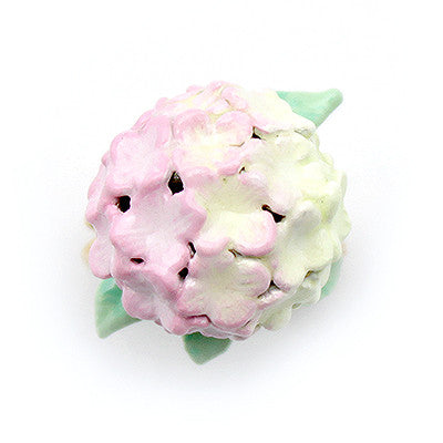 Handcrafted floral ring showcasing a beautiful soft pink hydrangea and green leaves.