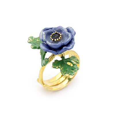 Handcrafted purple flower ring with with green leaves.