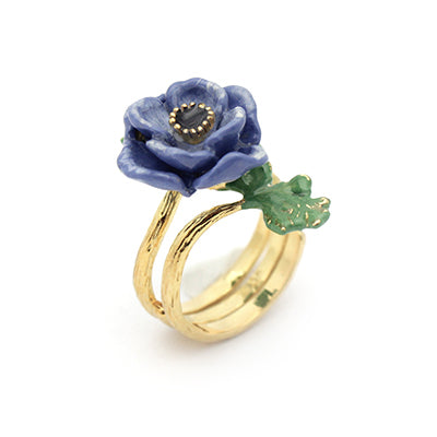 Stunning purple flower ring with green leaves, perfect for flower lovers.