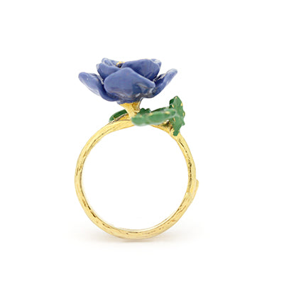 Handcrafted purple flower ring with with green leaves.