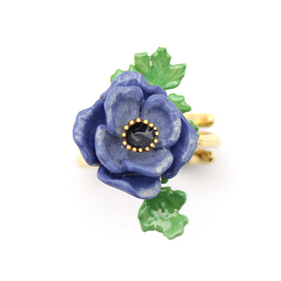 Stunning purple flower ring with green leaves, perfect for flower lovers.