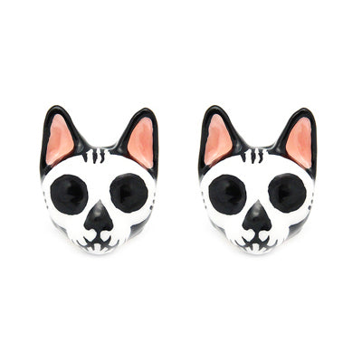 Stylish cat skull earrings with black and white design and pink accents.