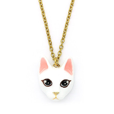 Adorable gold necklace with white cat's head pendant, perfect for cat lovers.