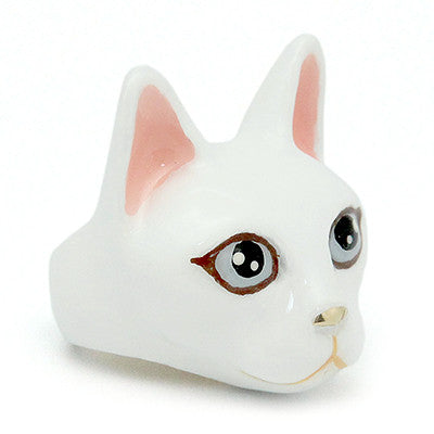 Handmade white cat head figurines with large black eyes, pink ears, and a small nose, perfect for cat lovers.