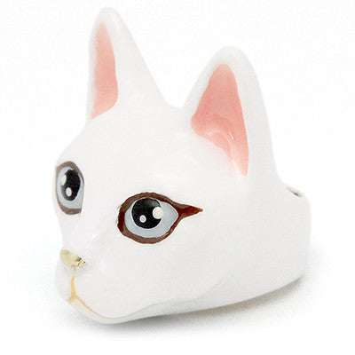 Handmade white cat head figurines with large black eyes, pink ears, and a small nose, perfect for cat lovers.