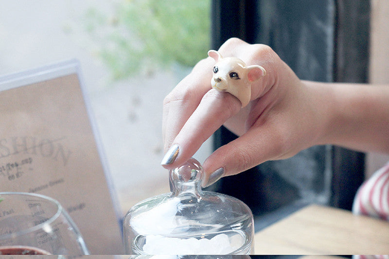 Woman wearing a cute dog ring on her finger.