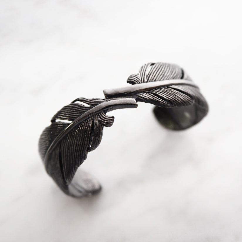 Artisan-crafted bracelet showcasing a beautiful feather design.