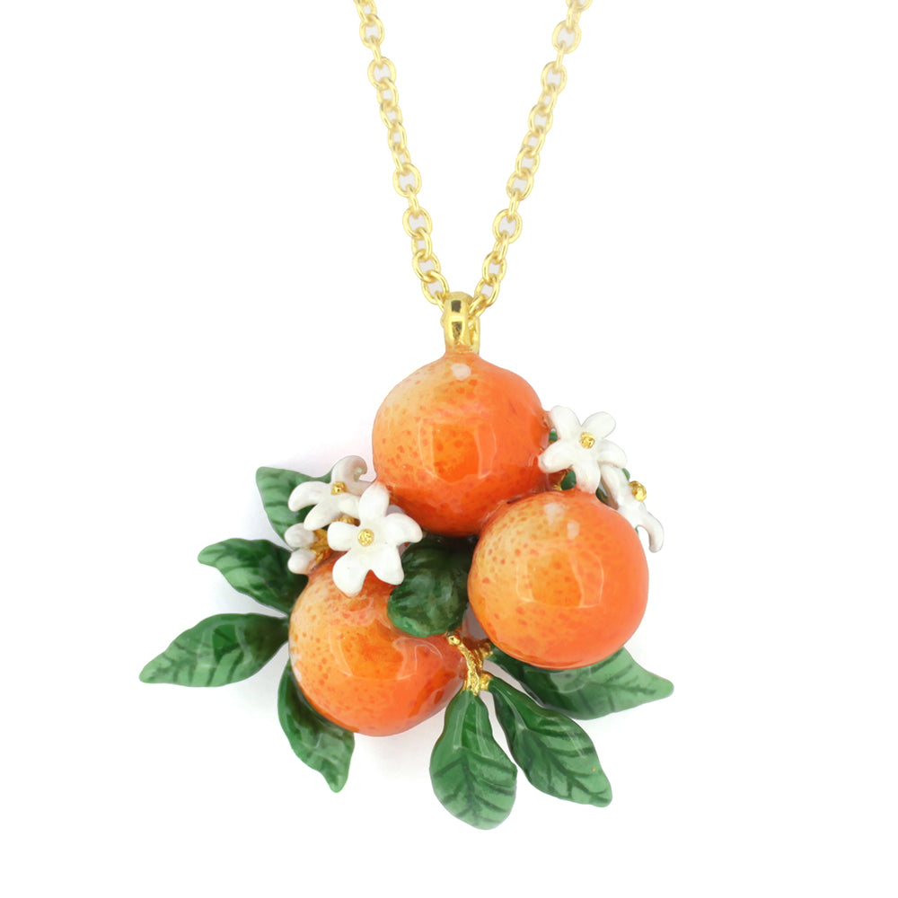 A golden chain necklace featuring three intricately crafted oranges surrounded by green leaves and tiny white flowers.