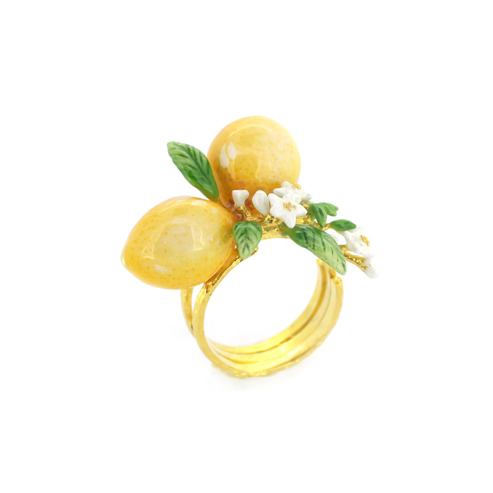 A charming gold ring featuring two yellow lemons, green leaves, and small white flowers, perfect for nature lovers.