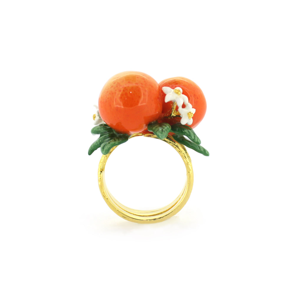 A charming gold ring featuring two oranges, green leaves, and small white flowers, perfect for nature lovers.