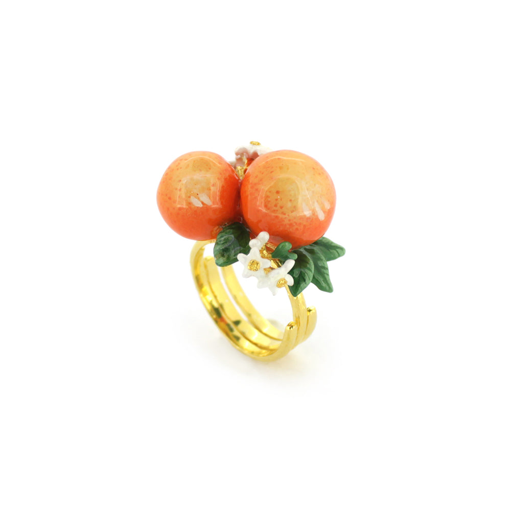 A charming gold ring featuring two oranges, green leaves, and small white flowers, perfect for summer fashion.