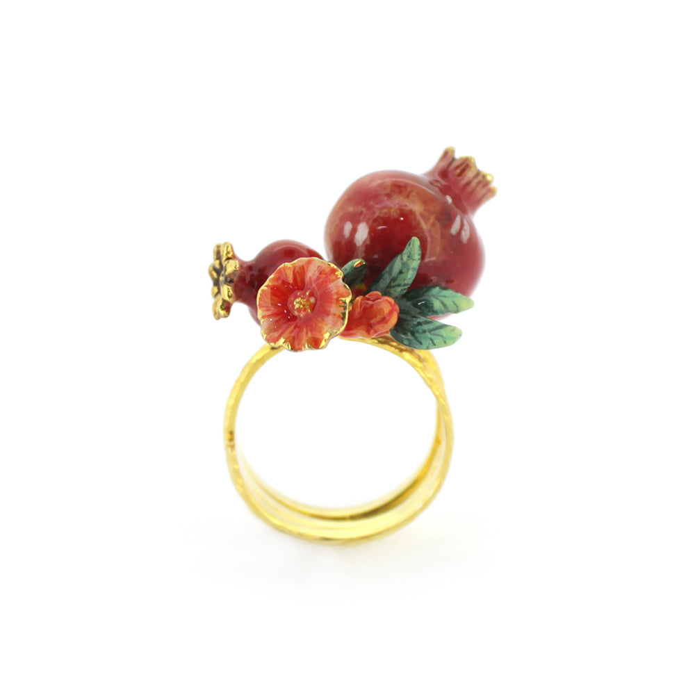 A charming gold ring featuring two pomegranates, green leaves, and small red flowers, perfect for nature lovers.