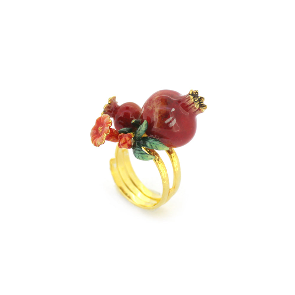 A charming gold ring featuring two pomegranates, green leaves, and small red flowers, perfect for nature lovers.