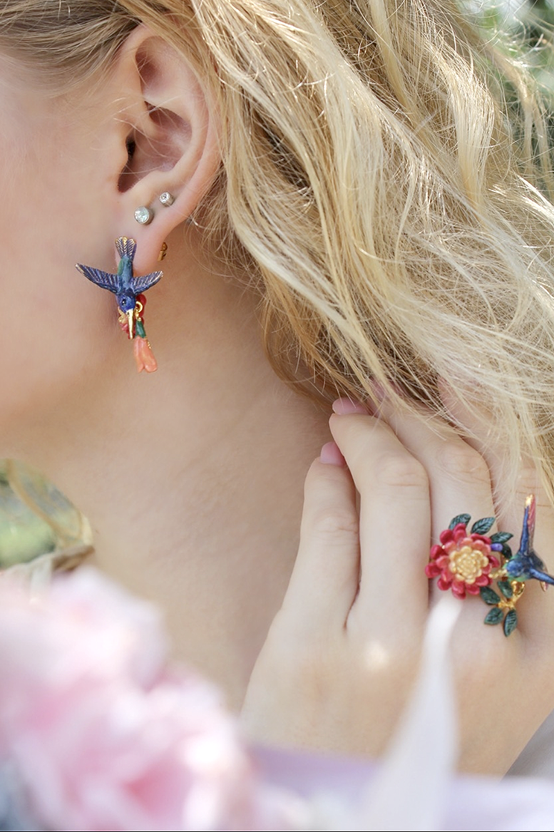 Nature-inspired jewelry with a focus on colorful bird with flowers earrings and a matching ring.