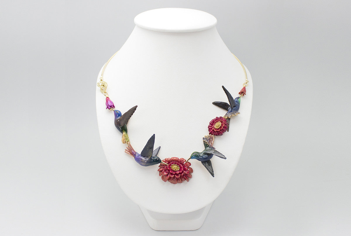 Nature-inspired necklace featuring hummingbirds and floral elements