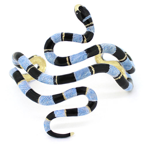 A sea snake bangle, featuring black, light blue, and gold accent, creating a bold, eye-catching look.