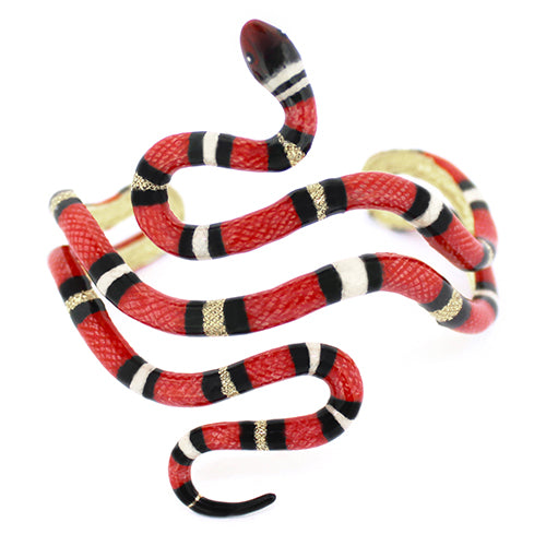 A striking red milk snake bangle, featuring black and white stripes, creating a bold, eye-catching look.