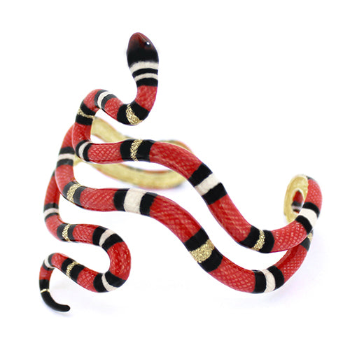 A striking red milk snake bangle, featuring black and white stripes, perfect for adding a unique touch to any outfit.