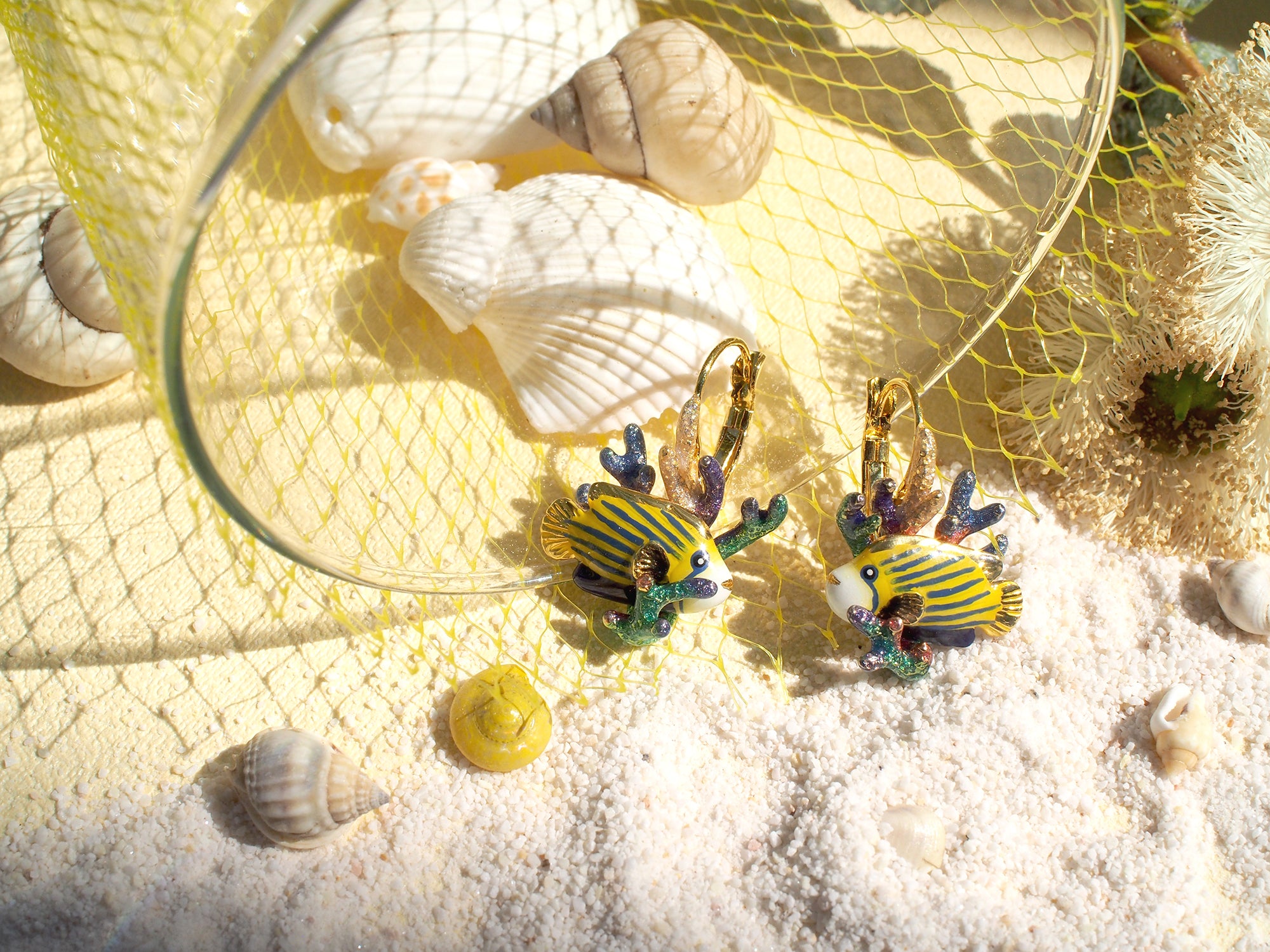 Unique beach-themed earrings featuring colorful fish with coral on a sandy background, ideal for summer fashion.