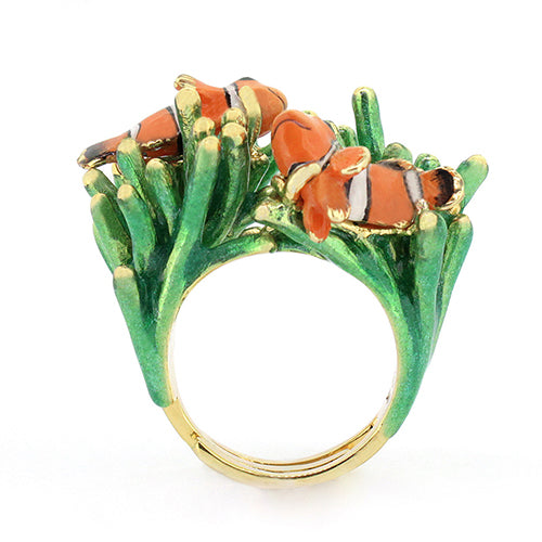 A whimsical ring featuring two clownfish on vibrant green coral.