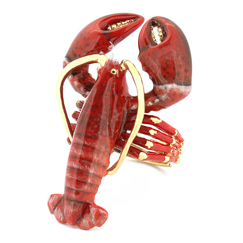 A whimsical lobster ring featuring a vivid red lobster design with gold accents.