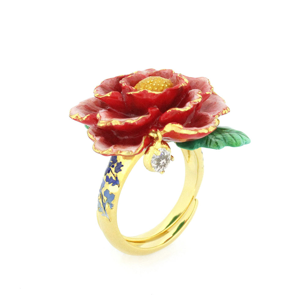 Gold ring featuring a red flower design with intricate petals, a green leaf, and a small diamond accent.