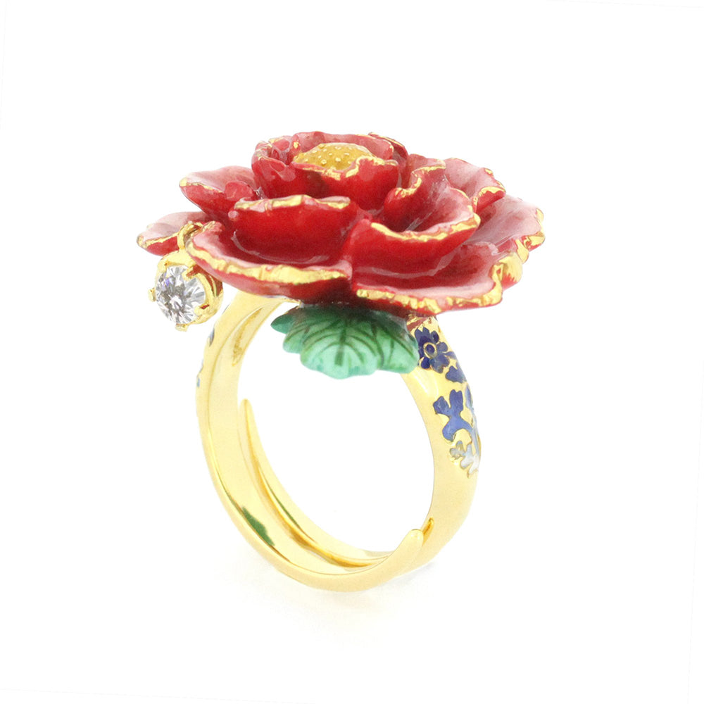 Beautiful gold ring featuring a red flower design with intricate petals, a green leaf, and a small diamond accent.