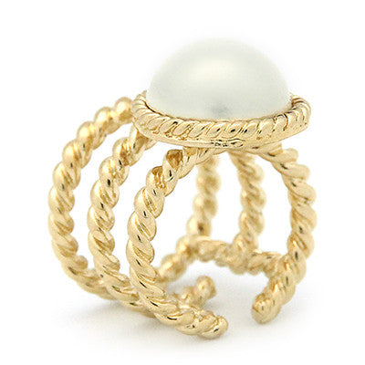 Unique gold ring with a braided rope design and a moon-like pearl.