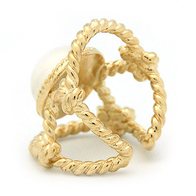 Gold ring with a large costume pearl surrounded by twisted rope design.