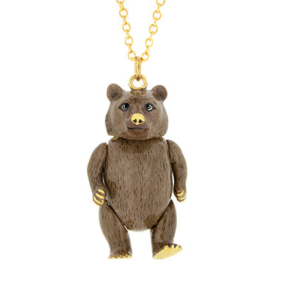 A cute grizzly bear pendant with a gold chain necklace.