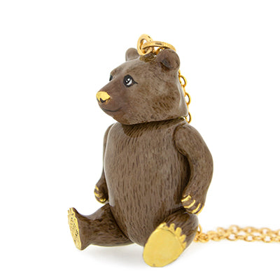 A gold necklace with a bear-shaped pendant that has detailed fur texture and realistic facial features.