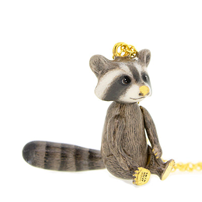 Raccoon pendant on a gold chain, featuring a cute design with intricate details, perfect for animal lovers.