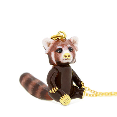 Nature-inspired necklace with a red panda pendant on a gold chain, featuring a cute design.