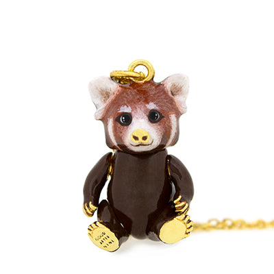 Nature-inspired necklace with a red panda pendant on a gold chain, featuring a cute design.