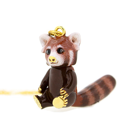 Adorable necklace with a red panda pendant on a gold chain, featuring a cute design.